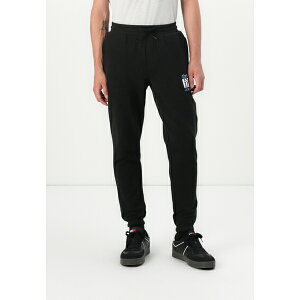 g~[qtBK[ Y T_ V[Y SLIM FLAG - Tracksuit bottoms - black