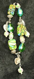 yzWG[EANZT[ xl`A~tBI[O[KXr[Yn[g`[uXbghand crafted venetian millifiore green glass bead and three heart charm bracelet
