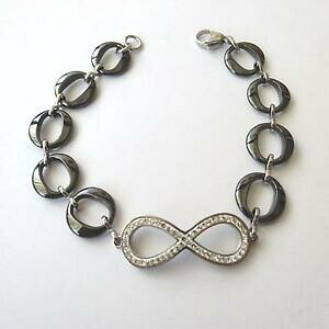 yzANZT[@lbNX@JtV{X`[ubNZ~bNzCgbracciale donna simbolo infinito acciaio ceramica nera zirconi bianchi 176 p